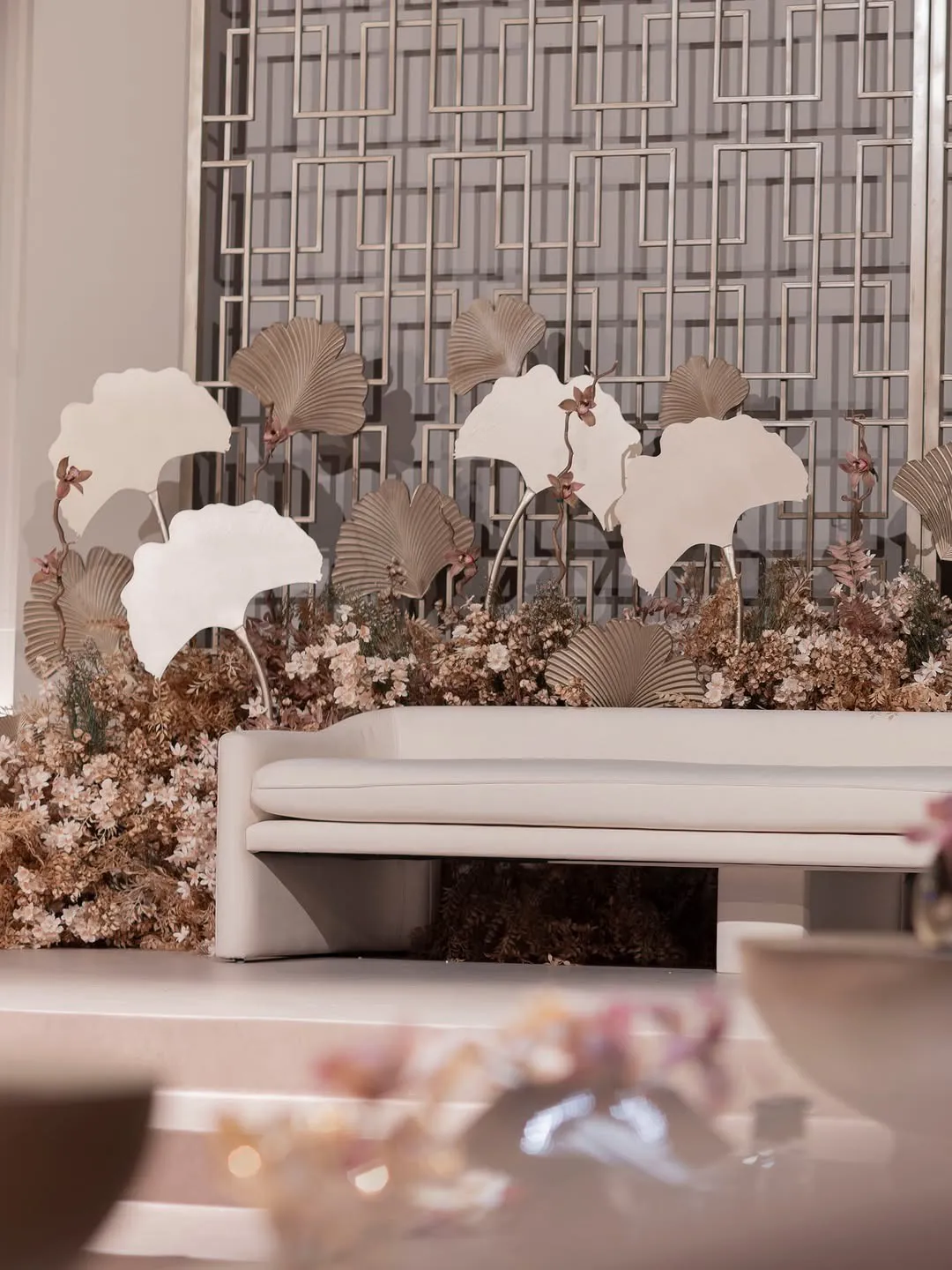 Close view of ginkgo-leaf sculptures and dried flowers on the bridal stage